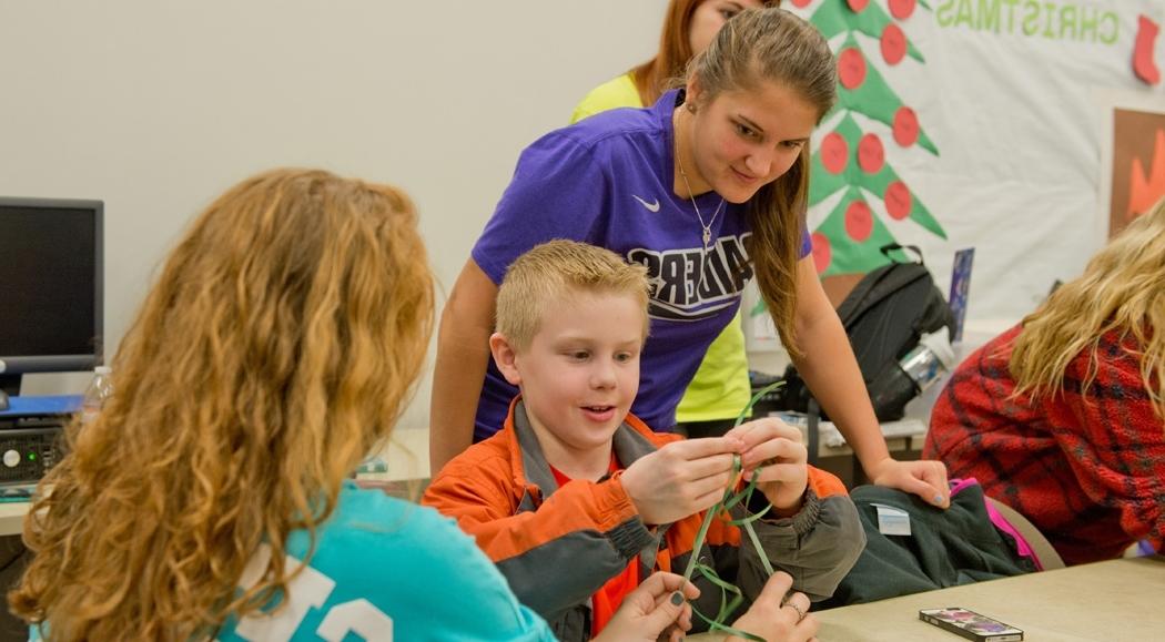 Early childhood education students teaching a child 